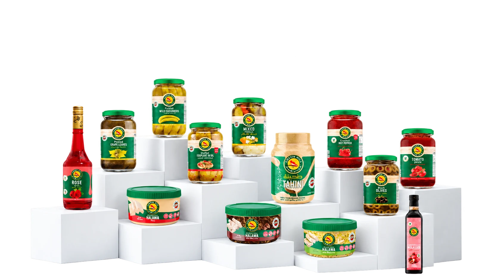 The Green Hill assortment displayed on white studio plinths, with pickles, olives, tahini, halawa, pantry favourites and syrups.